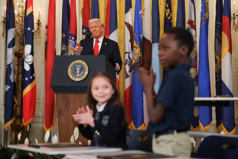president trump at a podium clapping for the destruction of the department of education